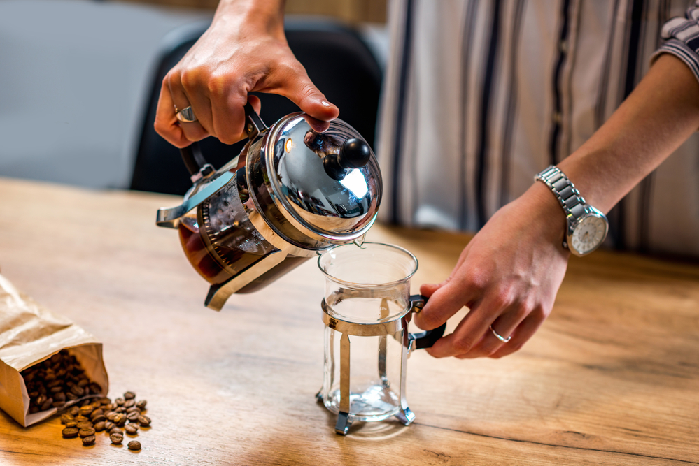A French press being used to make coffee